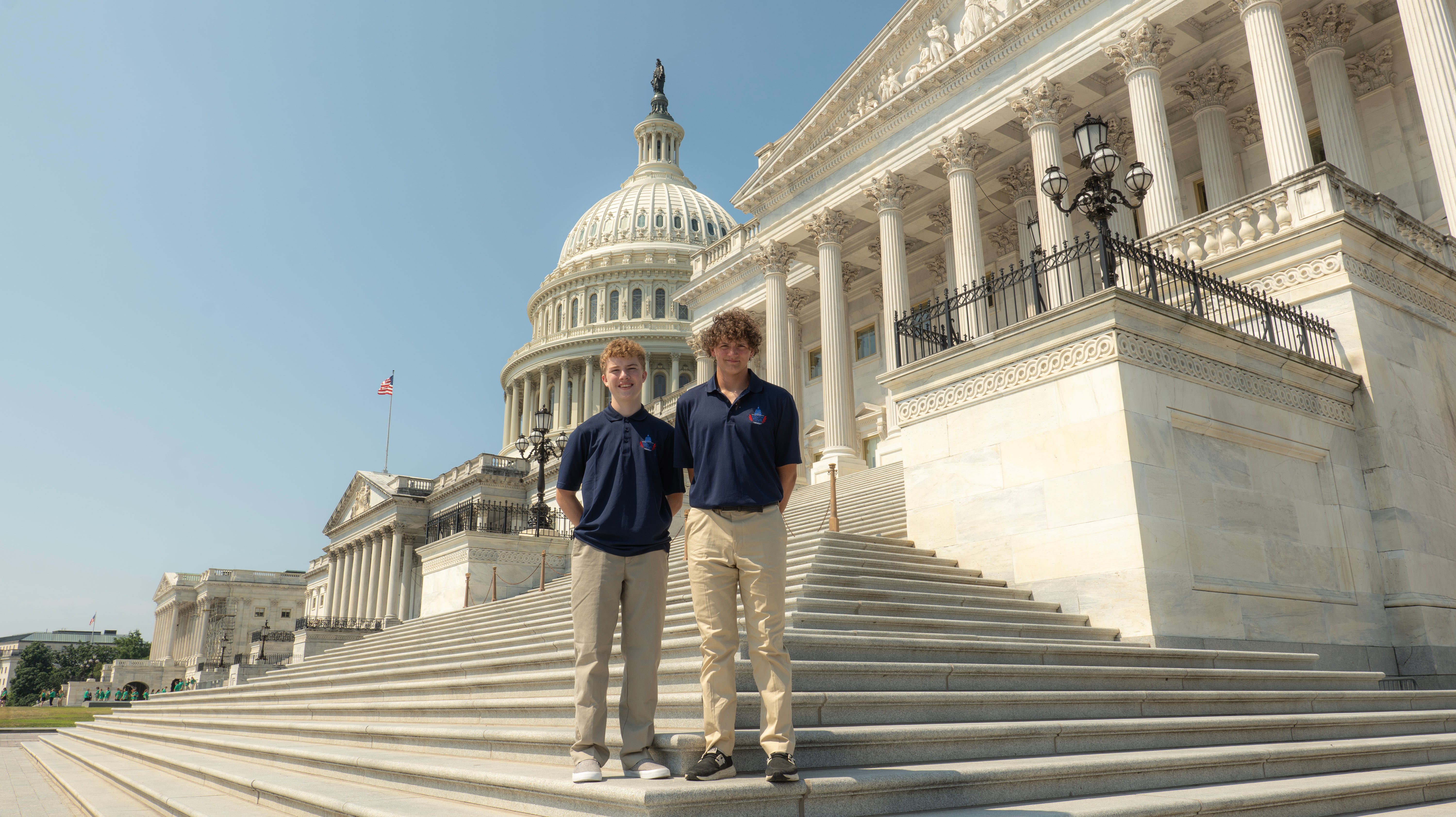 two teenage boys standing on the steps of the US Capital building