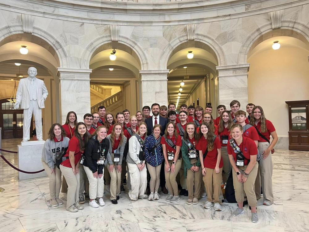 group of teenagers posing with JD Vance