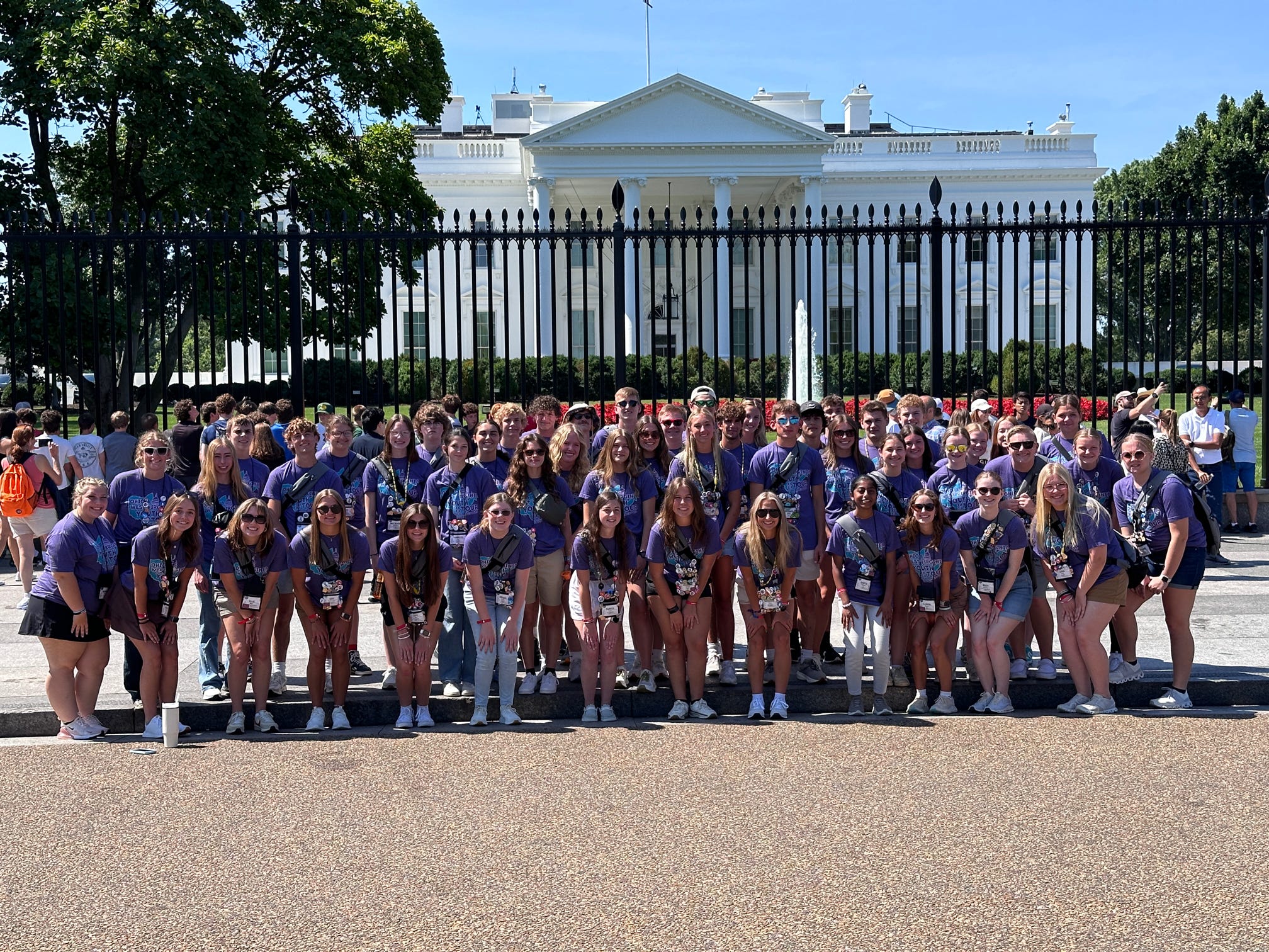 group of students posing in front of the white house