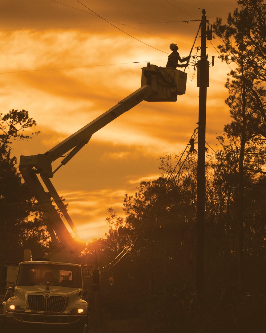 lineman in bucket truck at night