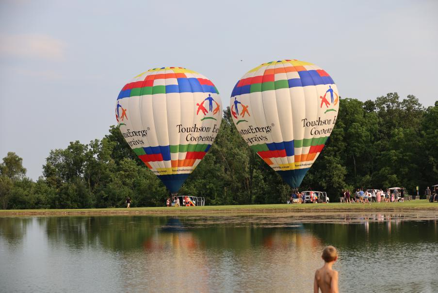 Two balloons inflated by pond