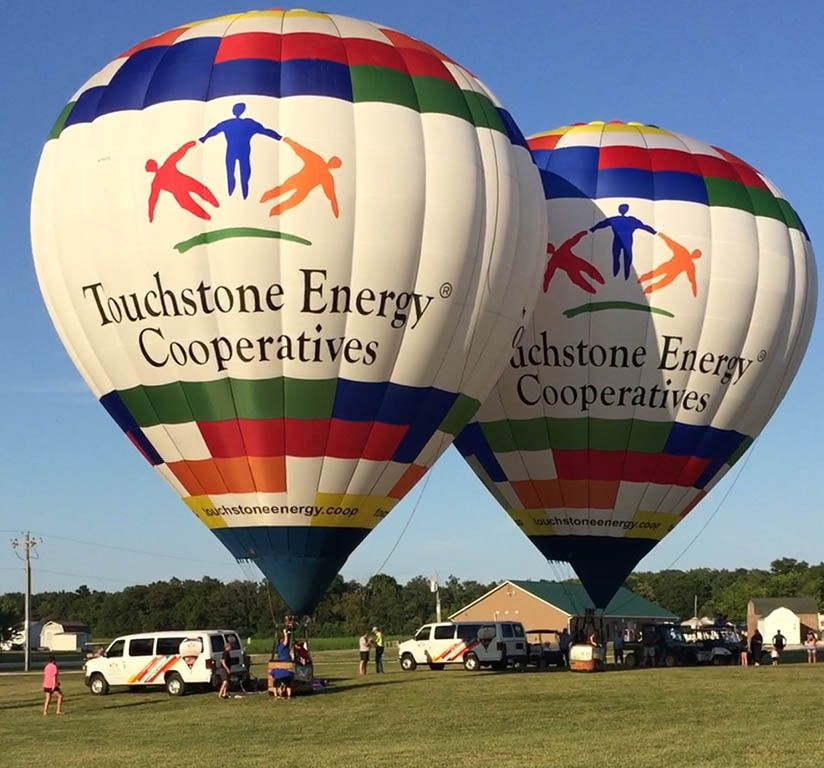Two Touchstone Energy hot air balloons at Hickory Acres Campground near Edgerton
