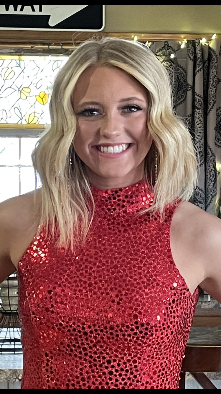 teenage girl with blonde hair wearing a red sequin dress