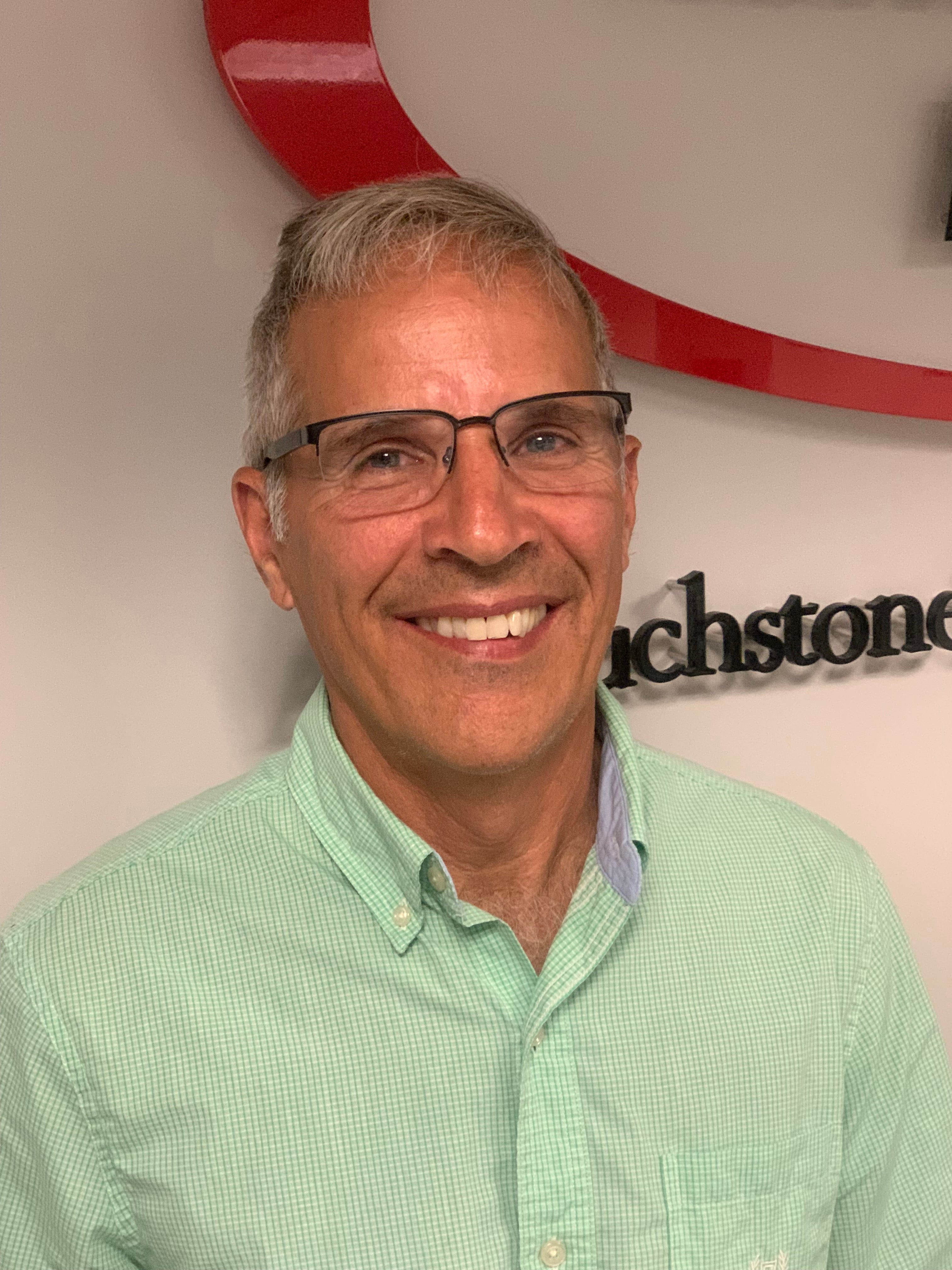 man with glasses wearing a green shirt