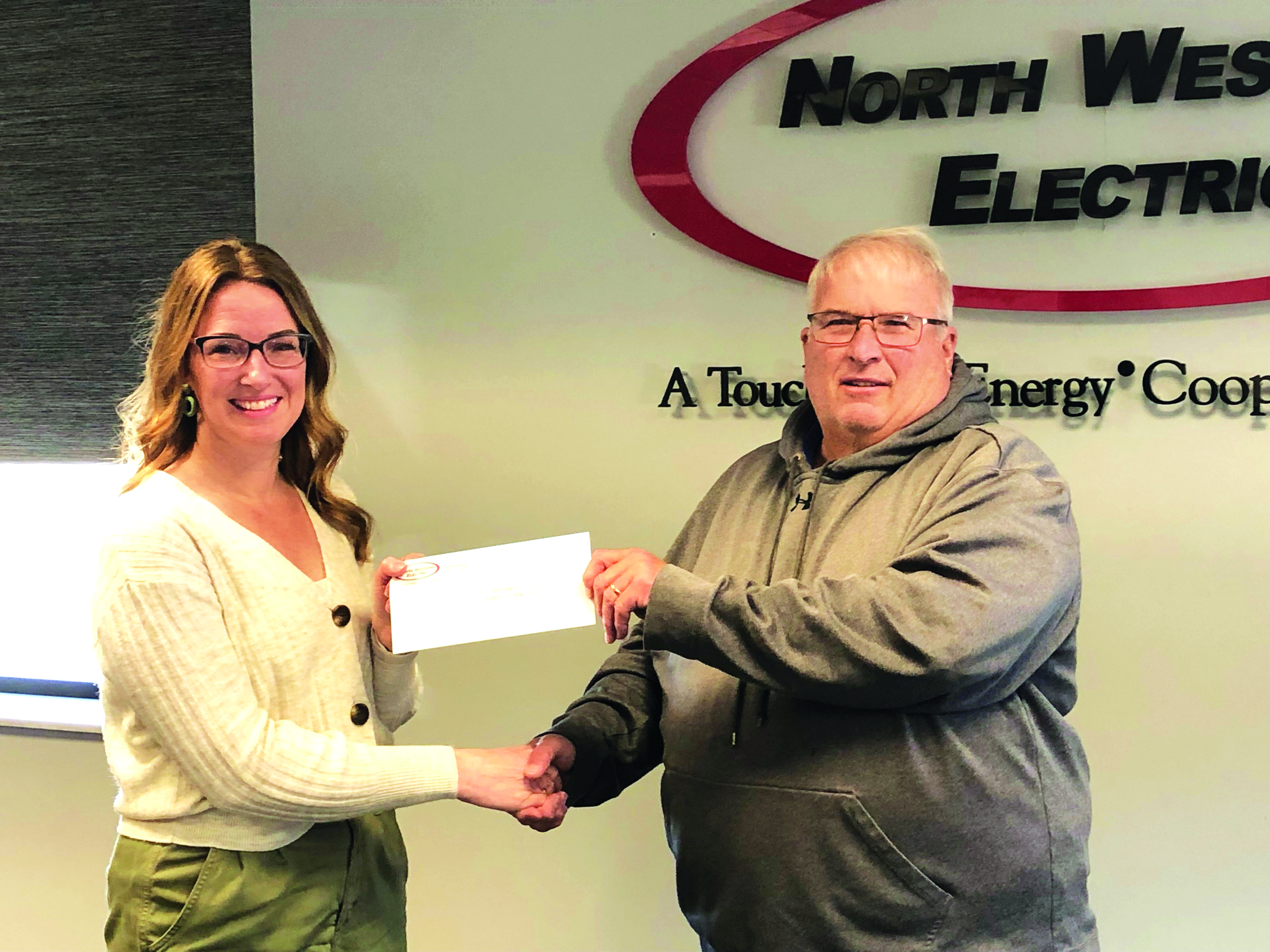 NWEC’s Director of Human Resources Tracey Carter presents Defiance County Agricultural Society President Jerry Sanders with the $1,050 donation.